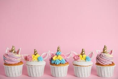 Photo of Many cute sweet unicorn cupcakes on pink  background