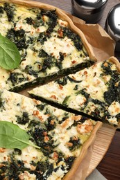 Photo of Delicious homemade spinach quiche on table, closeup