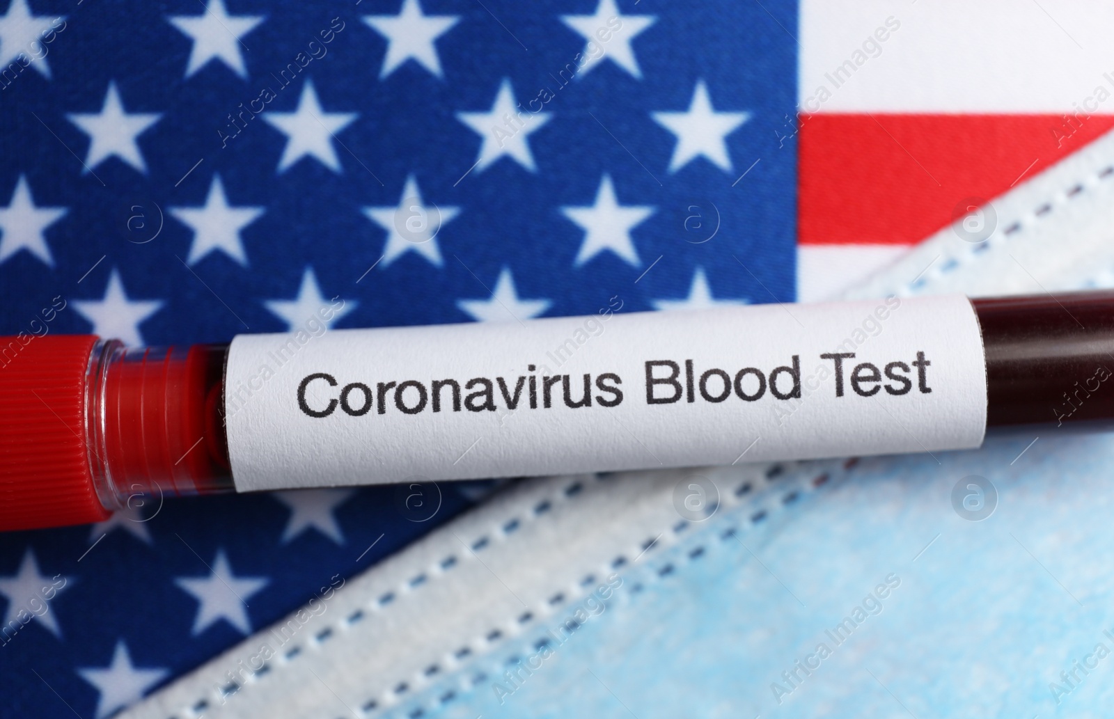 Photo of Test tube with blood sample and medical mask on American flag, flat lay. Coronavirus pandemic in USA