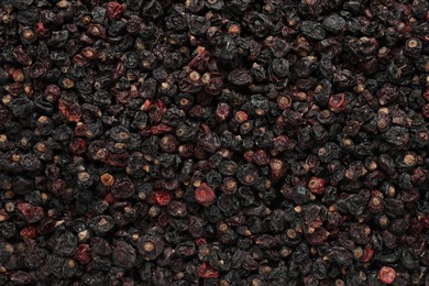 Heap of tasty dried currants as background, top view