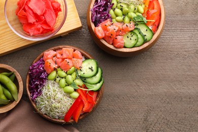 Photo of Delicious poke bowls with vegetables, fish and edamame beans on wooden table, flat lay. Space for text
