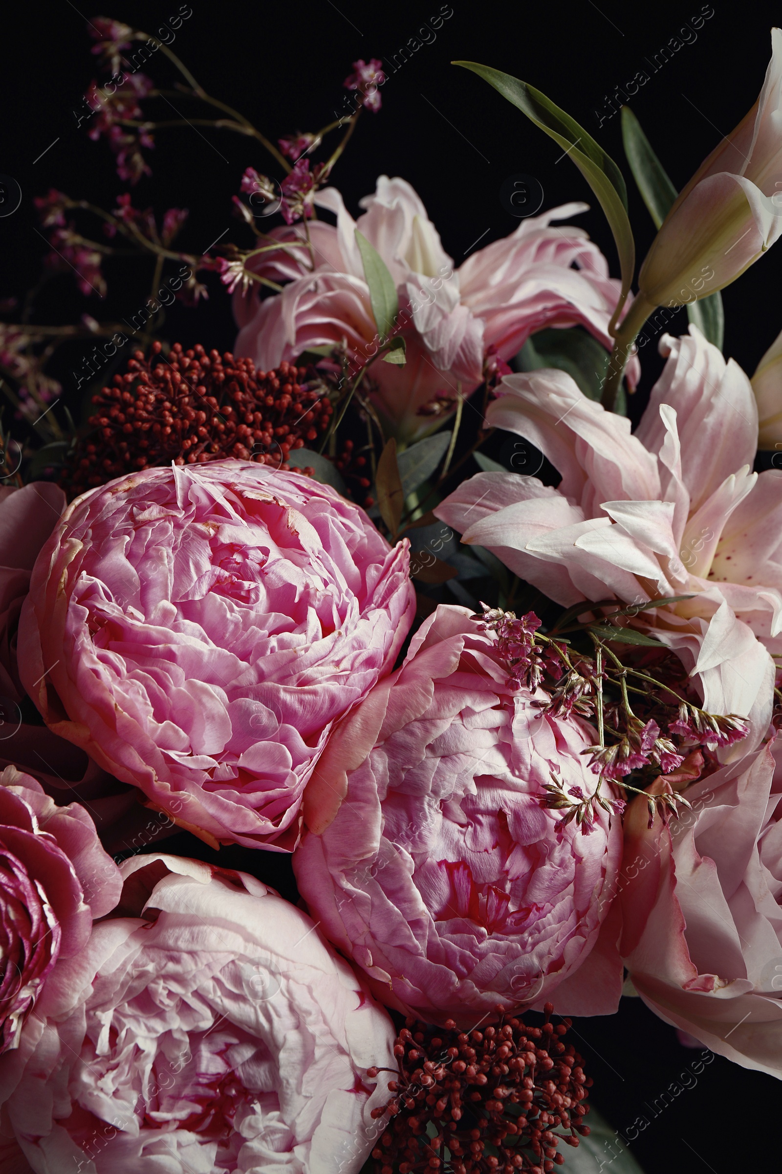 Photo of Beautiful bouquet of different flowers on black background, closeup. Floral card design with dark vintage effect