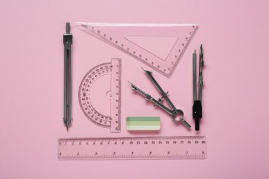 Photo of Flat lay composition with different rulers and stationery on pink background