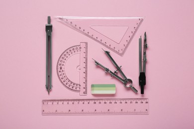 Flat lay composition with different rulers and stationery on pink background