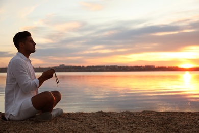 Photo of Man near river at sunset, space for text. Nature healing power