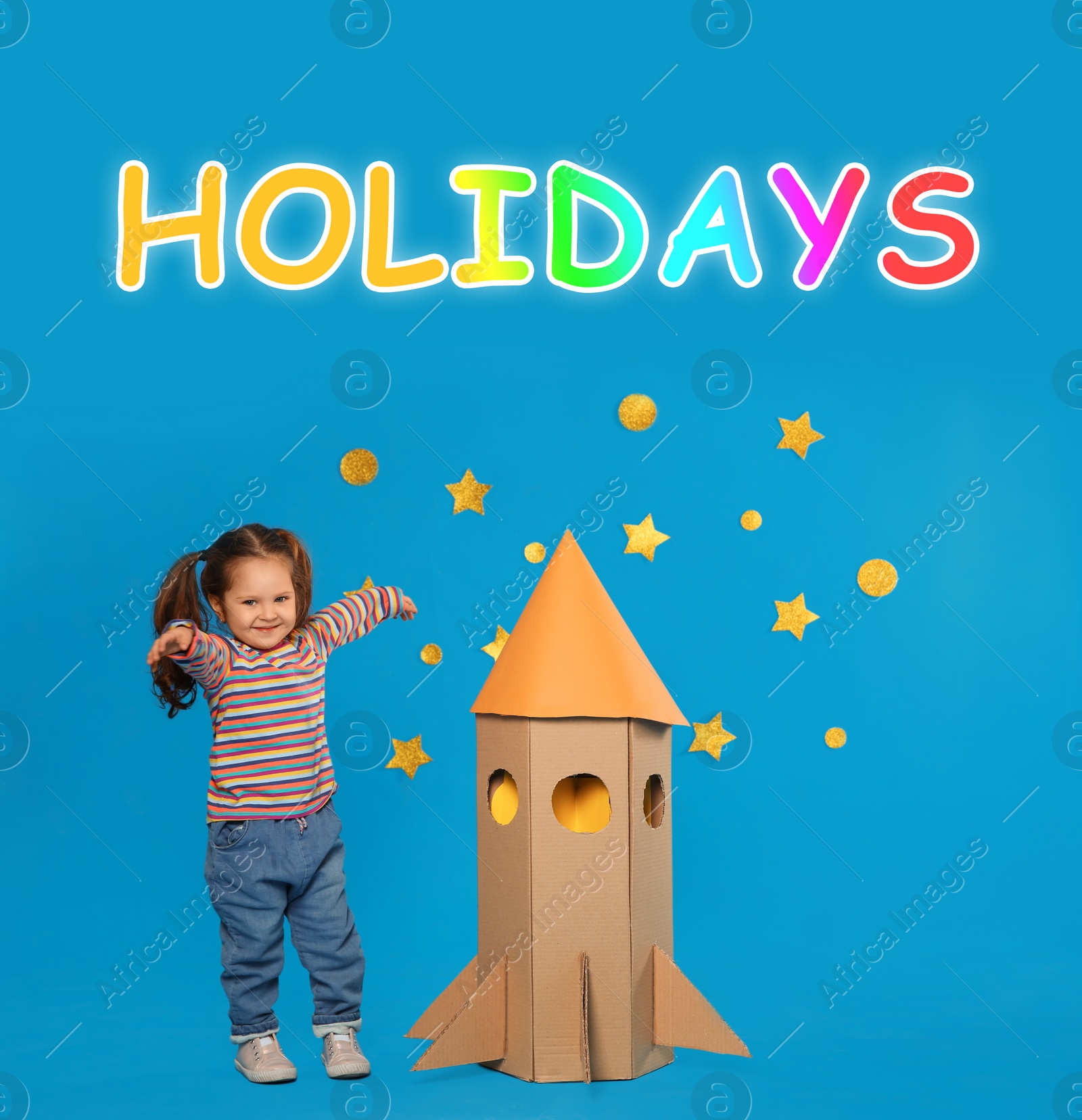 Image of School holidays. Cute little child playing with cardboard rocket near blue  wall