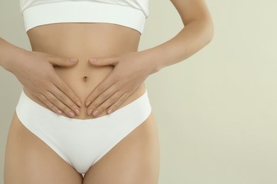 Gynecology. Woman in underwear on light background, closeup. Space for text