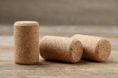 Corks of wine bottles on wooden table, closeup