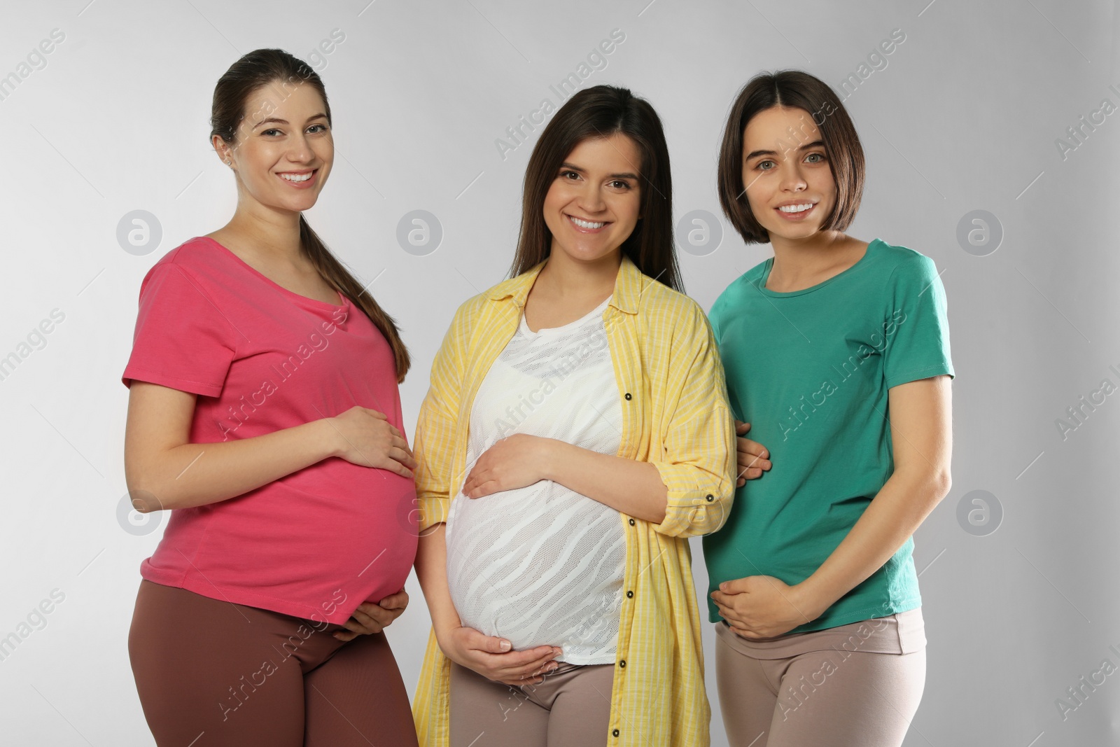 Photo of Happy young pregnant women on white background