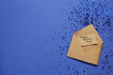 Photo of Card with phrase Happy Father's Day in envelope and confetti on blue background, top view. Space for text