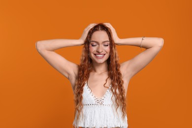 Photo of Beautiful young hippie woman on orange background