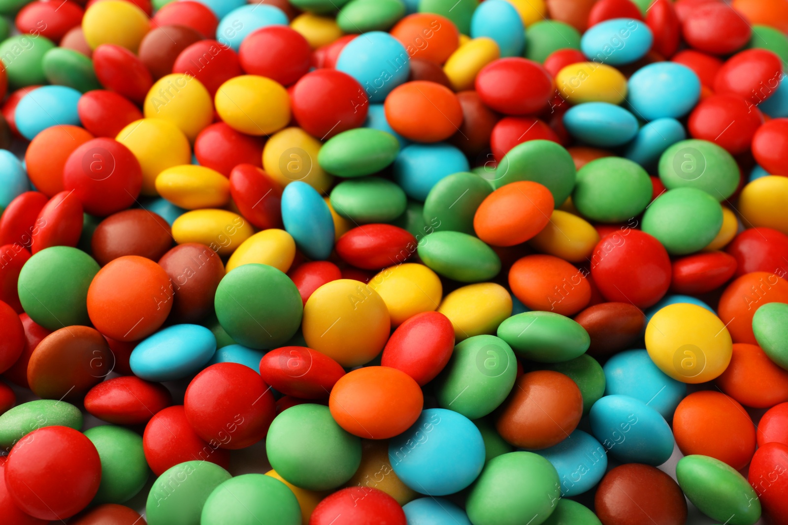 Photo of Many small colorful candies as background, closeup