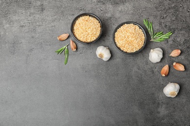 Photo of Flat lay composition with garlic products on grey background