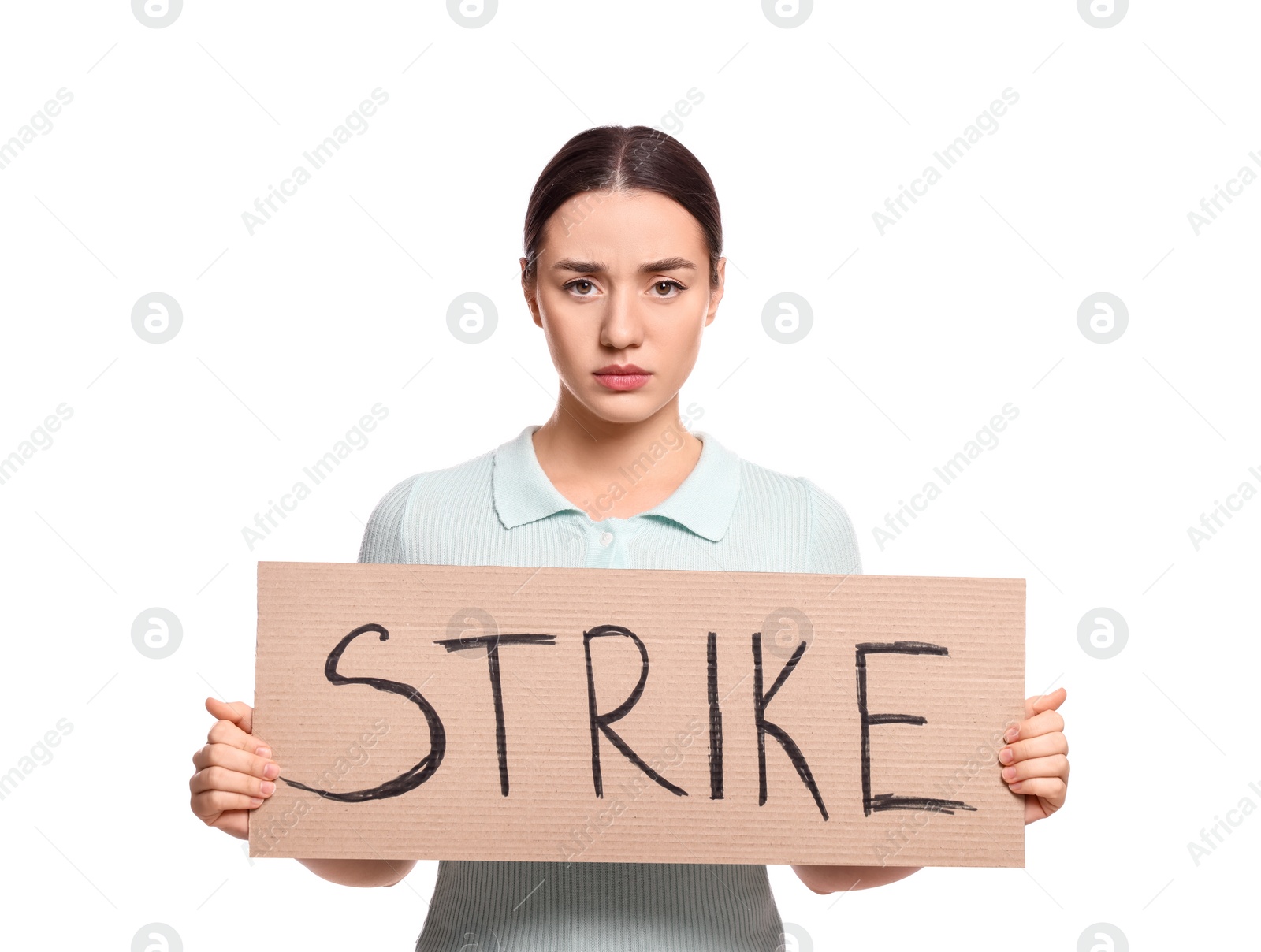 Photo of Upset young woman holding cardboard banner with word Strike on white background