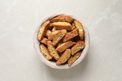 Traditional Italian almond biscuits (Cantucci) on light marble table, top view