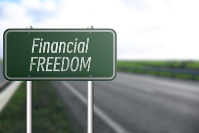 Image of Road sign with words Financial Freedom outdoors