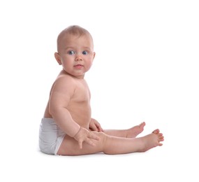 Cute baby in dry soft diaper sitting on white background