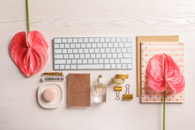 Photo of Creative flat lay composition with tropical flowers and computer keyboard on wooden background