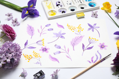 Photo of Composition with watercolor paints and floral picture on white background