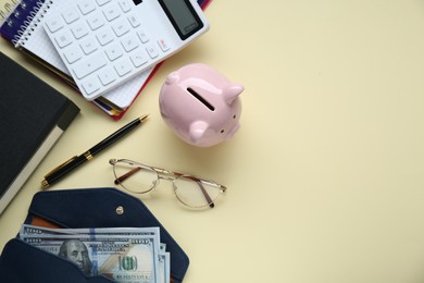 Photo of Flat lay composition with piggy bank, glasses and banknotes on beige background. Space for text