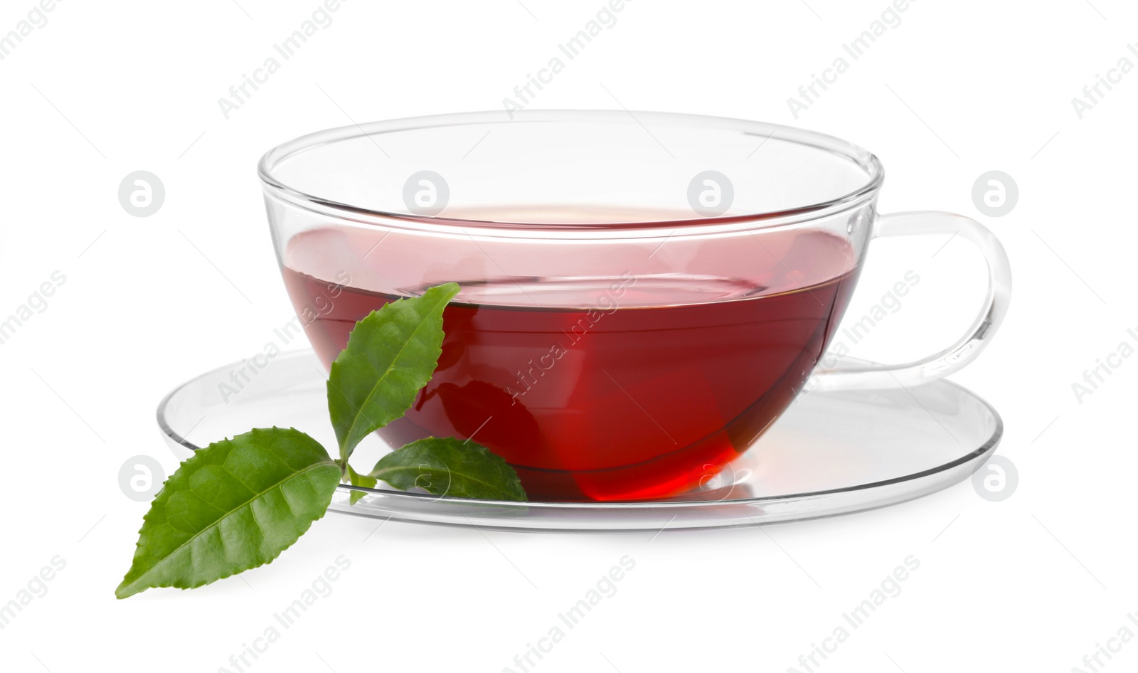 Photo of Glass cup of hot aromatic tea and green leaves on white background