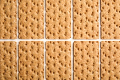 Photo of Fresh rye crispbreads on white wooden table, flat lay