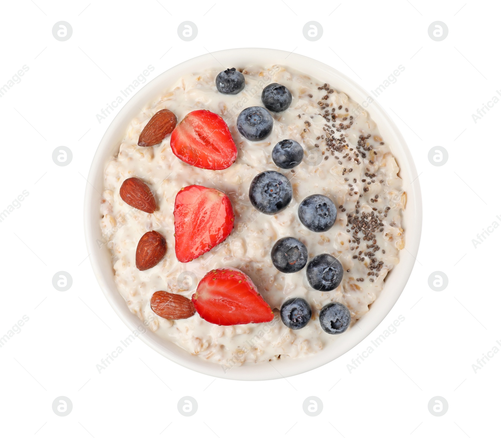 Photo of Tasty boiled oatmeal with berries, almonds and chia seeds in bowl isolated on white, top view