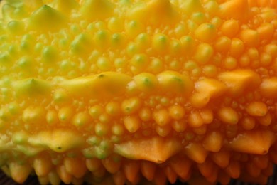 Photo of Beautiful fresh bitter melon as background, closeup