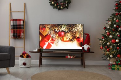 Photo of Stylish living room interior with modern TV and Christmas decor