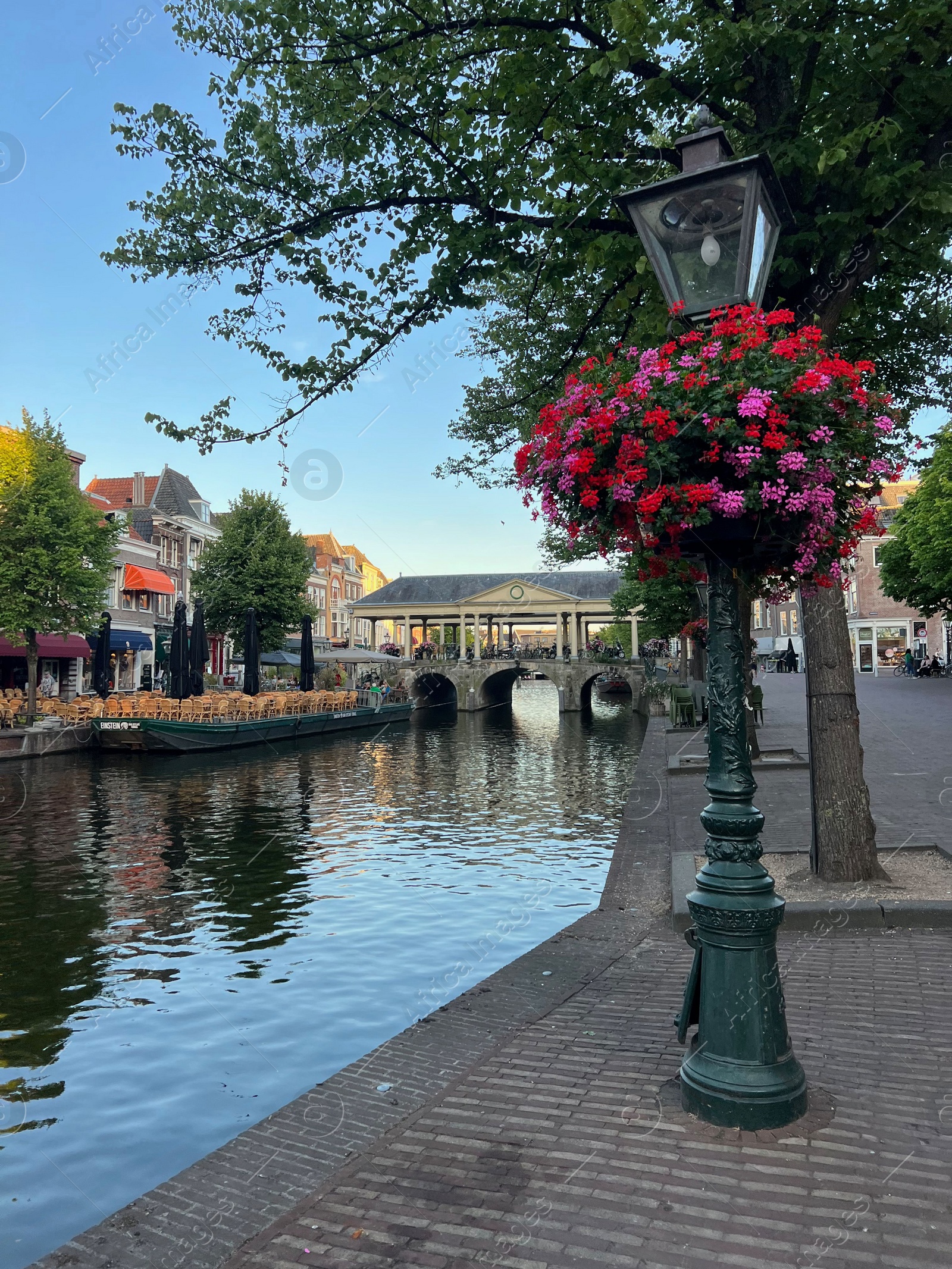 Photo of Leiden, Netherlands - August 1, 2022: Picturesque view of city canal and beautiful buildings