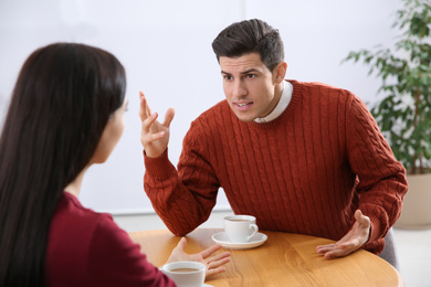 Couple having quarrel in cafe. Relationship problems