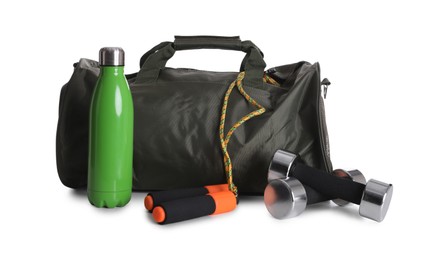 Sports bag and gym equipment on white background
