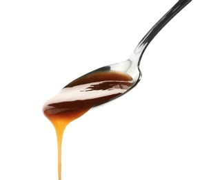 Spoon with delicious caramel sauce on white background