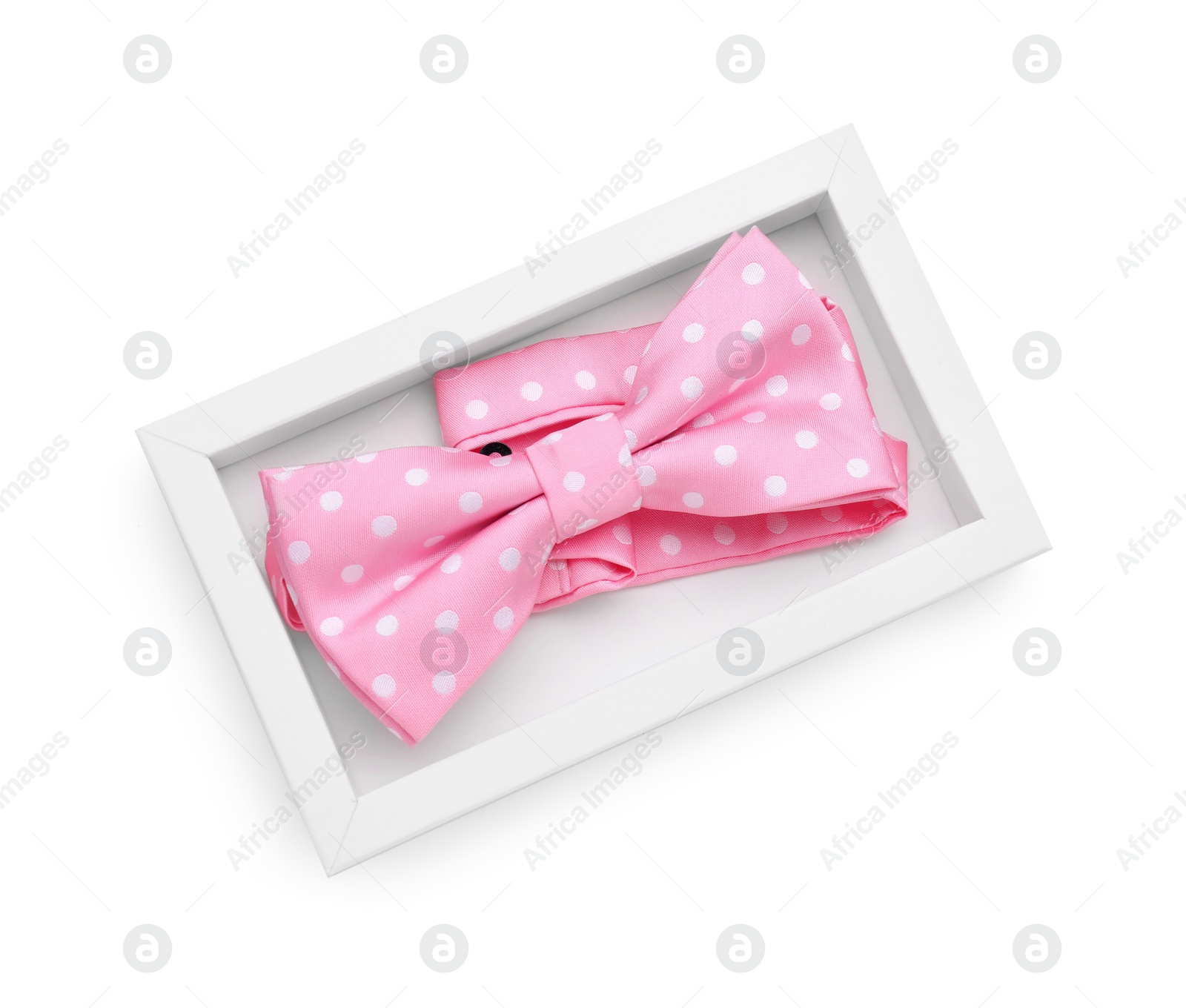 Photo of Stylish pink bow tie with polka dot pattern on white background, top view