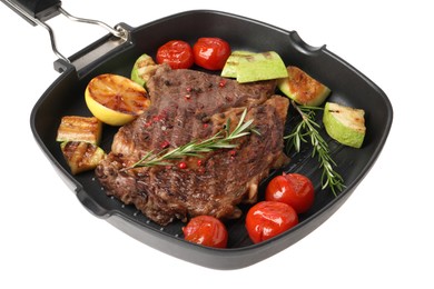 Photo of Delicious grilled beef steak and vegetables in frying pan isolated on white