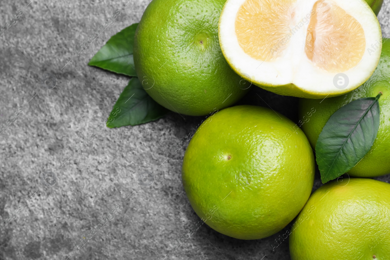 Photo of Fresh ripe sweeties on grey table, flat lay. Space for text