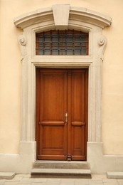 Photo of View of building with wooden door. Exterior design