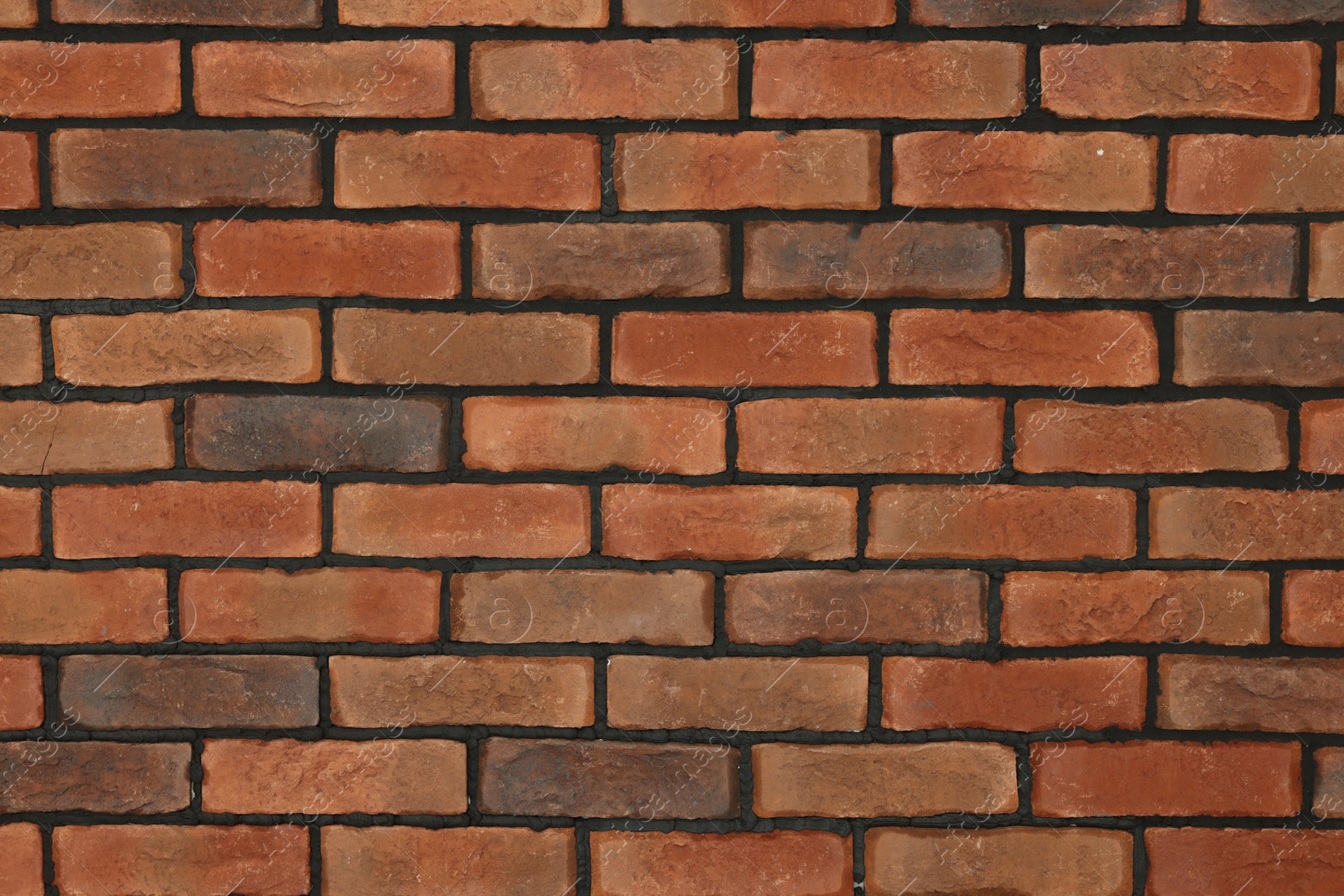 Photo of Decorative bricks on wall as background. Interior design. Tiles installation process
