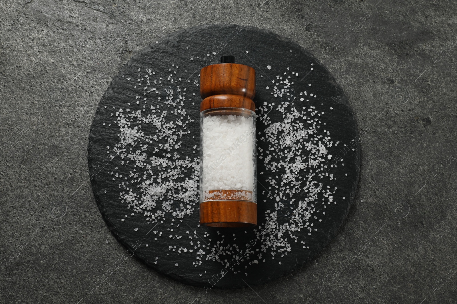 Photo of Salt shaker on grey textured table, top view