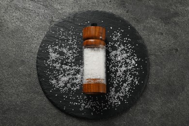 Photo of Salt shaker on grey textured table, top view