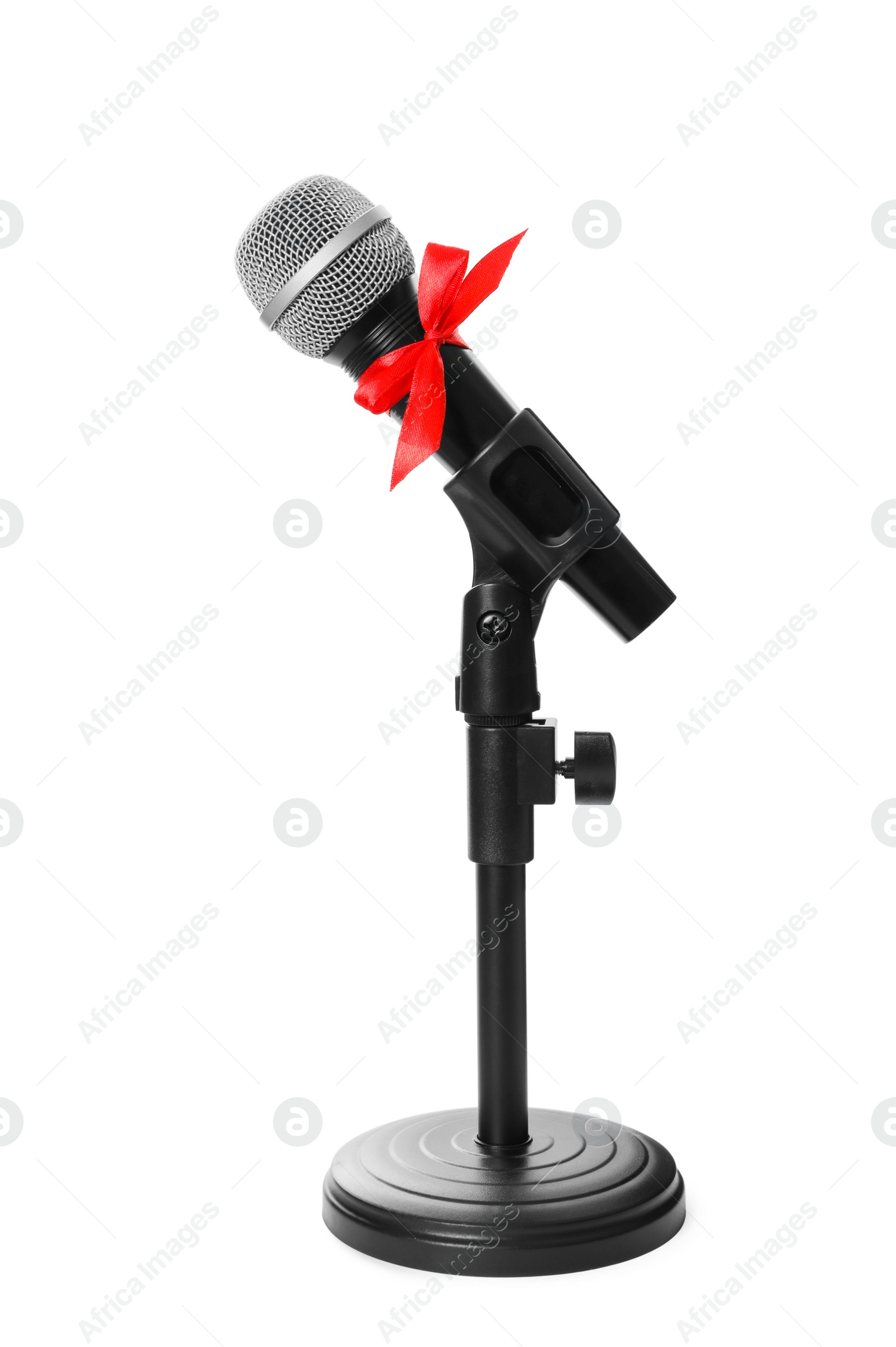 Photo of Microphone with red bow isolated on white. Christmas music