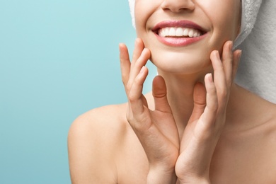 Young woman with silky skin on color background, closeup