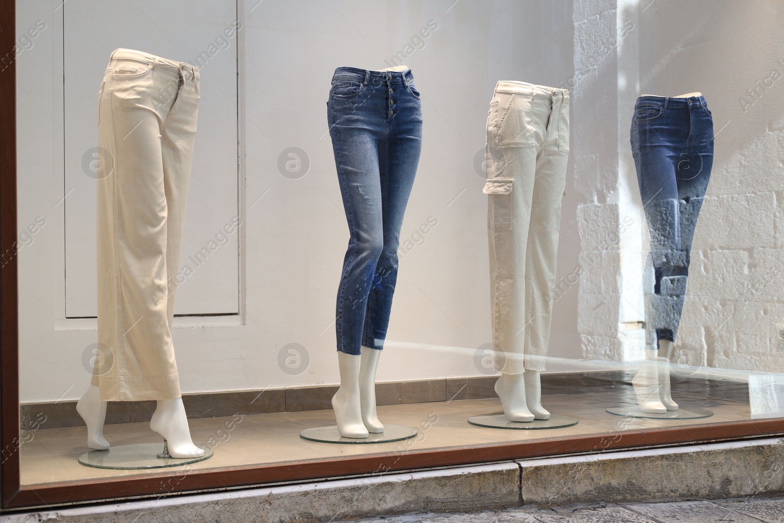 Photo of Shop display with mannequins in stylish pants