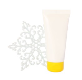Photo of Tube of hand cream and snowflake isolated on white. Winter skin care