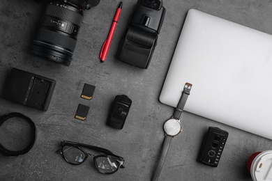 Flat lay composition with photographer's equipment and accessories on grey background