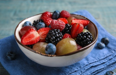 Photo of Fresh tasty fruit salad on table, closeup