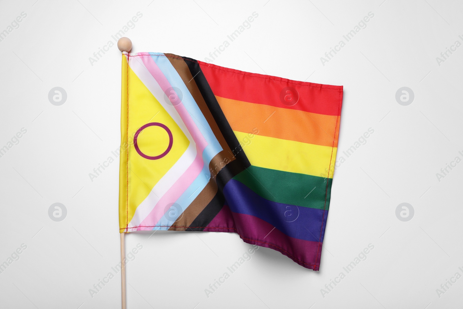 Photo of Bright progress flag on white background. LGBT pride