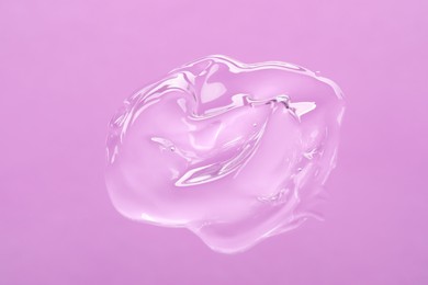 Photo of Sample of cleansing gel on violet background, top view. Cosmetic product