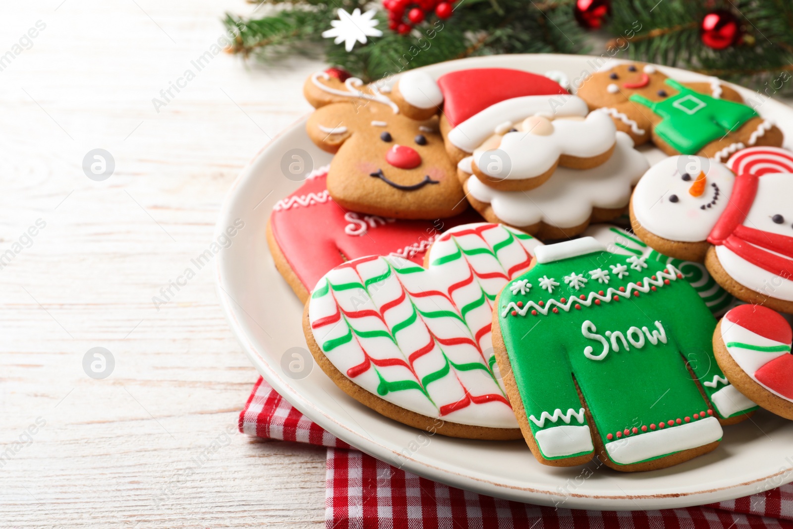 Photo of Delicious Christmas cookies on white wooden table, closeup