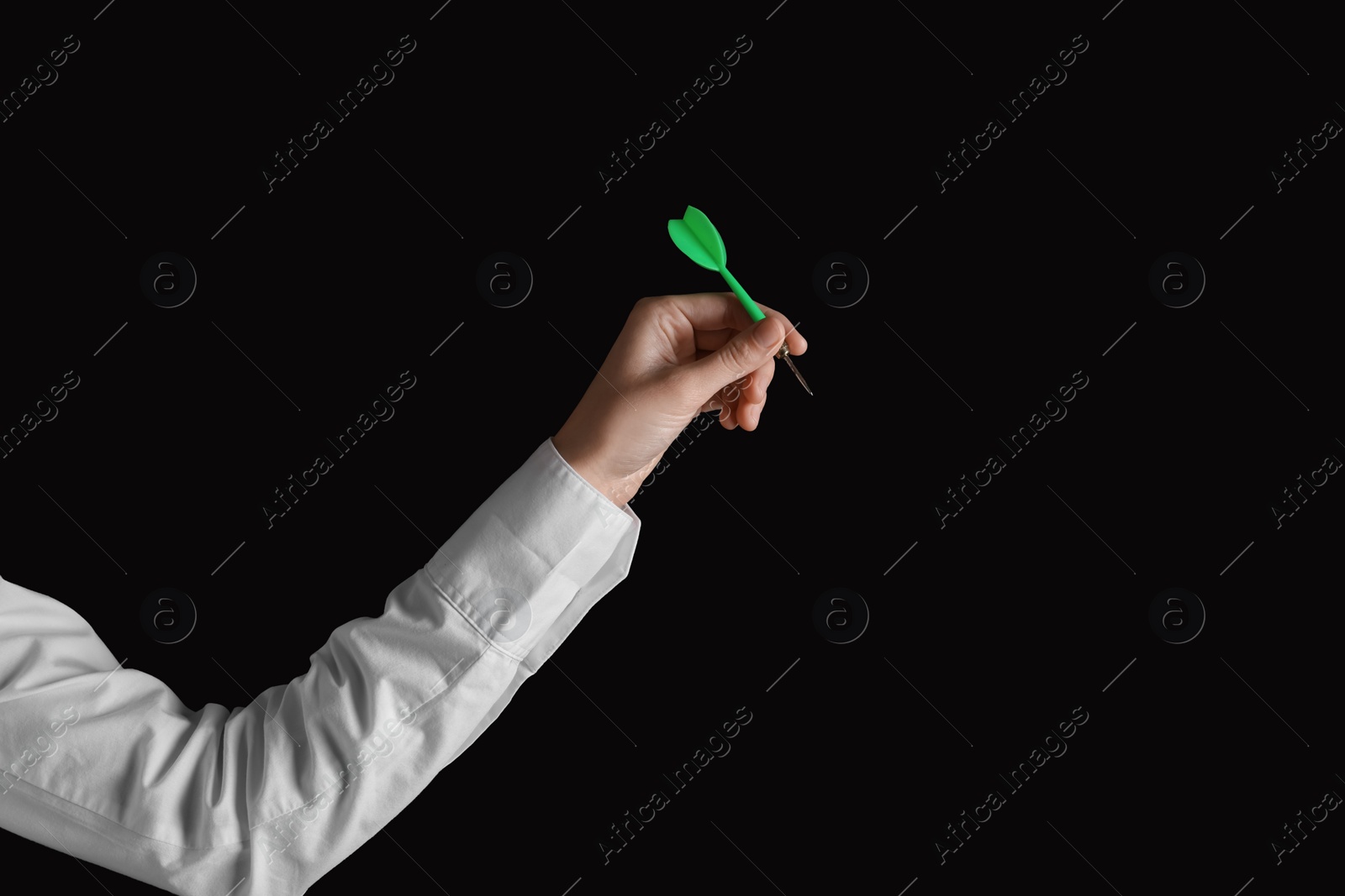 Photo of Businesswoman holding green dart on black background, closeup. Space for text